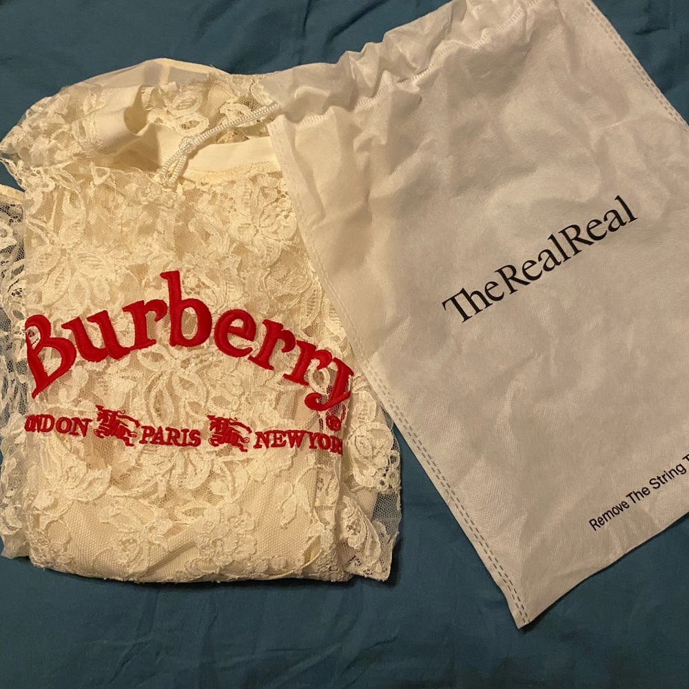 Burberry white lace shirt with a cami underneath.